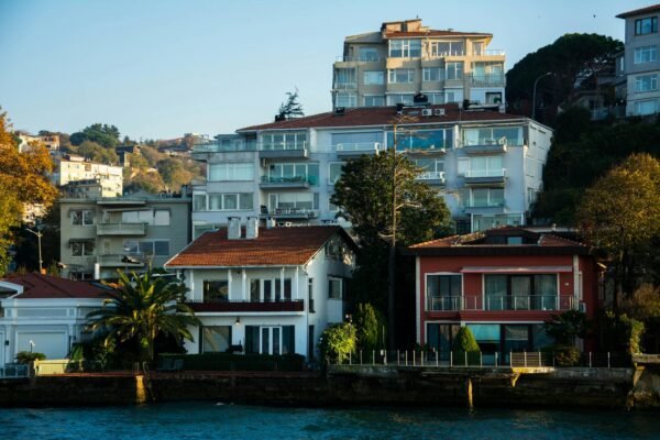 Charming waterfront residential buildings with glass facades under clear skies.