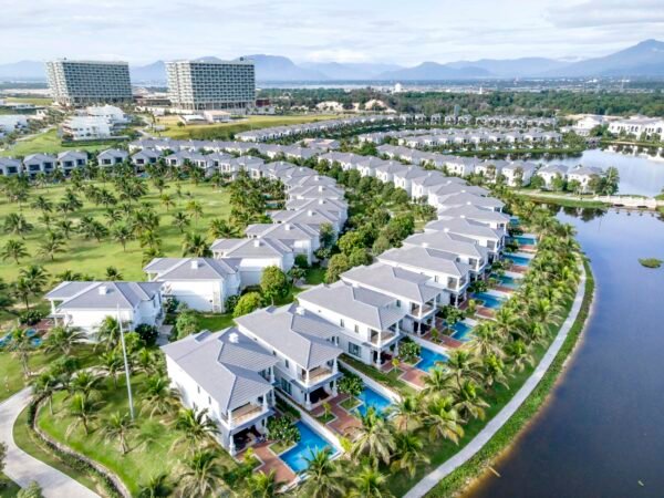 Stunning aerial image showcasing luxury villas with private pools at a resort in Vietnam.