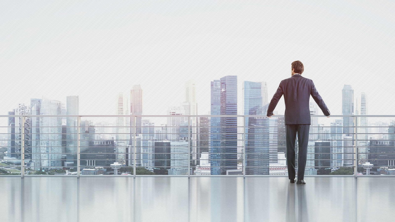 a businessman ovelooking the city from office